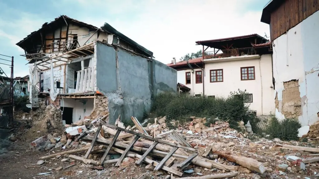 A village destroyed by an earthquake, showcasing damaged buildings and debris.