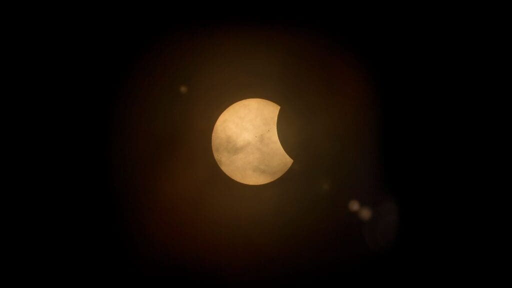Captured partial solar eclipse set against a deep dark sky, perfect for astronomy enthusiasts.
